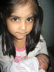 Big sister Hibah holds her little sister Tanya